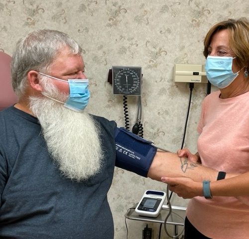 A man with a beard and a woman wearing masks.