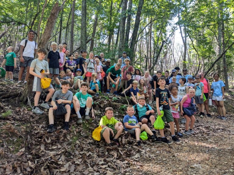 Group of kids posing in a forest.